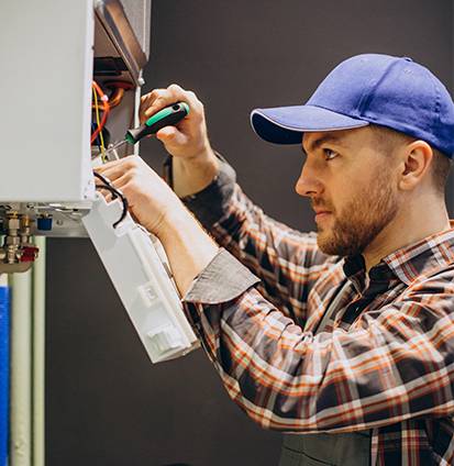 service-man-adjusting-house-heating-system