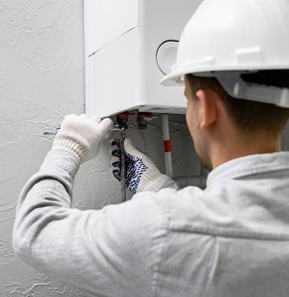 worker-repairing-water-heater